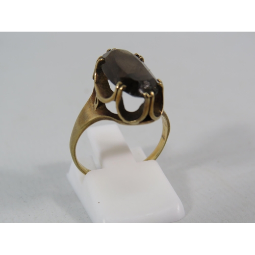 139 - 9ct Gold ring set with a 17mm by 10mm Smokey Quartz stone, finger size 