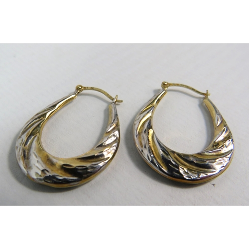 141 - Pair of 9ct two tone Gold oval creole earrings, 1 gram.