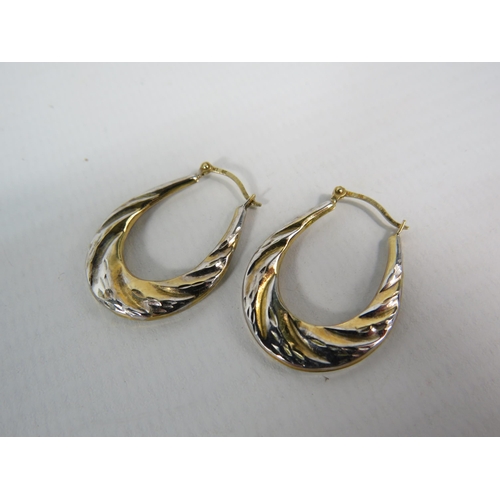 141 - Pair of 9ct two tone Gold oval creole earrings, 1 gram.