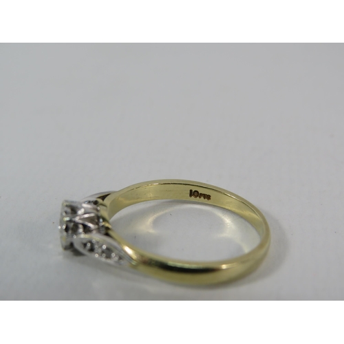 150 - 9ct Gold 10pt Diamond set solitaire ring with two small diamonds set to each shoulder, finger size 