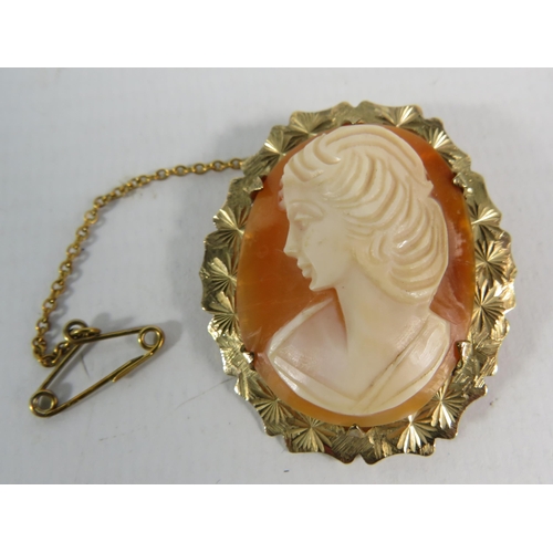 189 - Cameo brooch with 9ct gold surround and safety chain, total weight 6.2 grams. 38mm by 32mm.