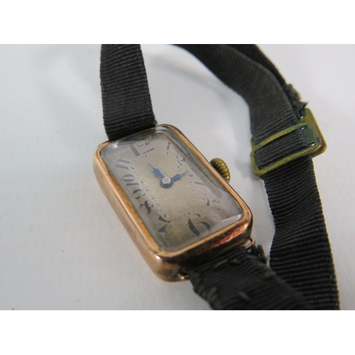 195 - Antique 9ct Rose gold ladies wristwatch with material strap in running order.