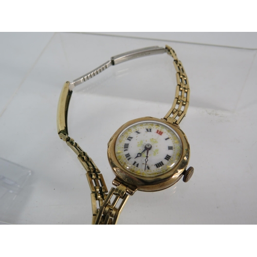 196 - Vintage ladies 9ct gold enamel face wristwatch with rolled gold strap, in running order.