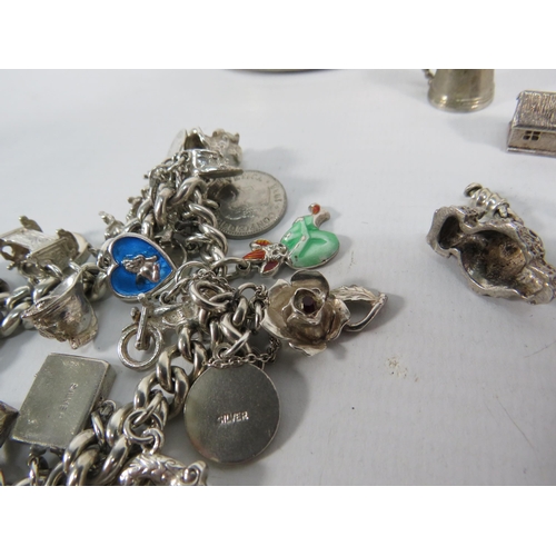 199 - A Sterling silver charm bracelet with over 30 charms plus a white metal trinket box. 118 grams of si... 