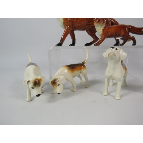 311 - Large Beswick Fox, Small Beswick fox and four hounds.