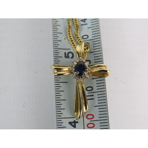 322 - 14ct gold crucifix set with a oval sapphire and diamonds on a 16