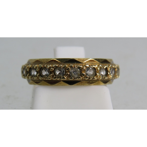 323 - 9ct gold eternity ring set with clear topaz stones, finger size 