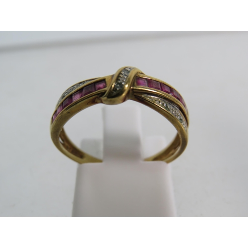 326 - 9ct Rose gold Ruby and diamond crossover ring, finger size 