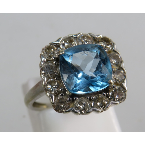 327 - 9ct White gold ring set with a large blue topaz 8mm by 8mm which is surrounded by approx 1 cts of Di... 