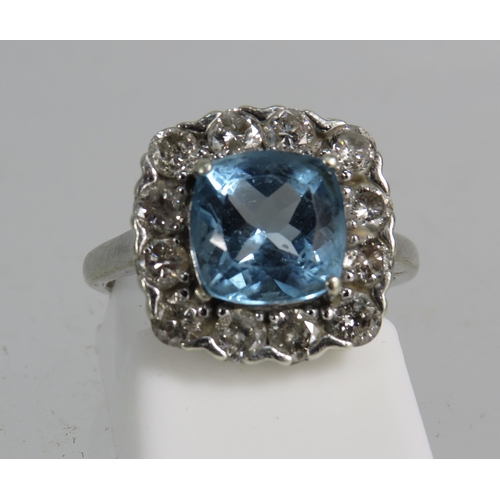 327 - 9ct White gold ring set with a large blue topaz 8mm by 8mm which is surrounded by approx 1 cts of Di... 