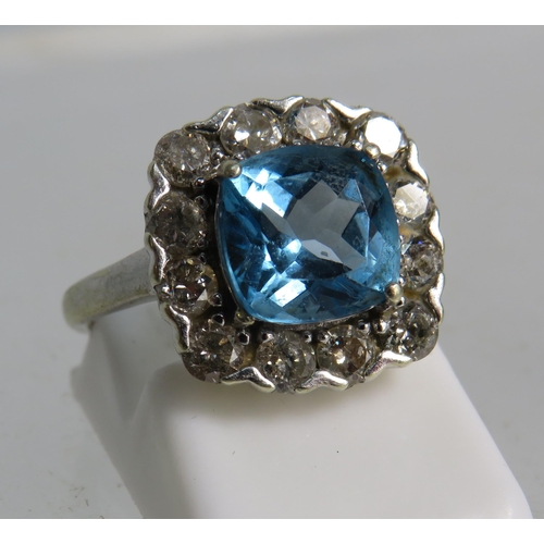 327 - 9ct White gold ring set with a large blue topaz 8mm by 8mm which is surrounded by approx 1 cts of Di... 