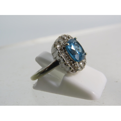 327 - 9ct White gold ring set with a large blue topaz 8mm by 8mm which is surrounded by approx 1 cts of Di... 