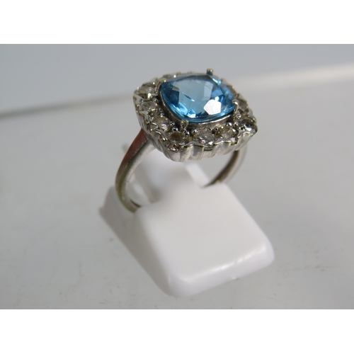 327 - 9ct White gold ring set with a large blue topaz 8mm by 8mm which is surrounded by approx 1 cts of Di... 