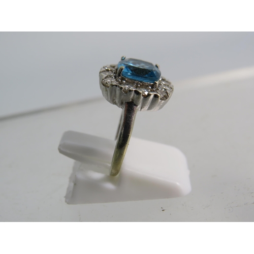 327 - 9ct White gold ring set with a large blue topaz 8mm by 8mm which is surrounded by approx 1 cts of Di... 