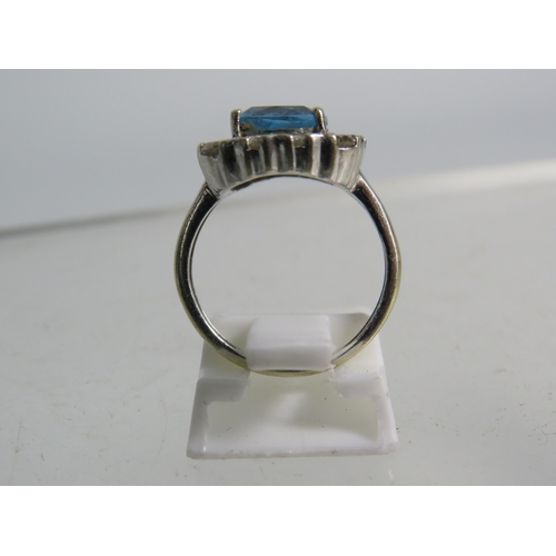 327 - 9ct White gold ring set with a large blue topaz 8mm by 8mm which is surrounded by approx 1 cts of Di... 