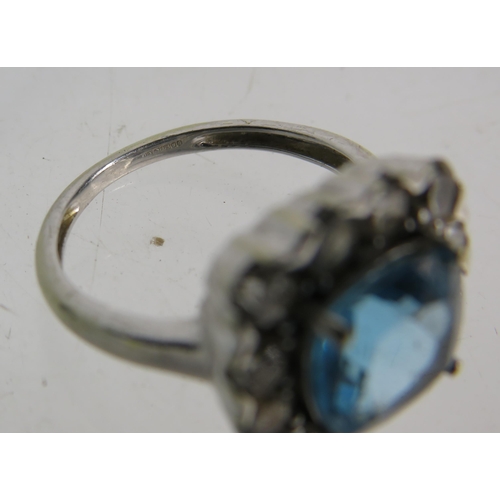 327 - 9ct White gold ring set with a large blue topaz 8mm by 8mm which is surrounded by approx 1 cts of Di... 