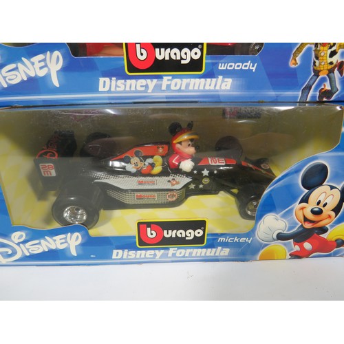 879 - Five Burago 1:24 Scale Disney F1 Models plus one with out box. See photos