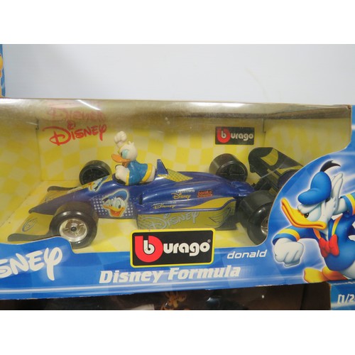 879 - Five Burago 1:24 Scale Disney F1 Models plus one with out box. See photos