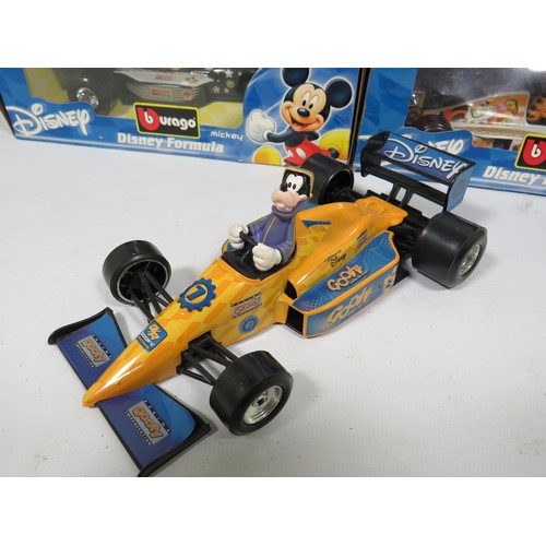 879 - Five Burago 1:24 Scale Disney F1 Models plus one with out box. See photos