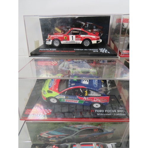 887 - Eight Die Cast Model Rally cars in hard perspex cases.  See photos for details.