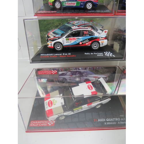 887 - Eight Die Cast Model Rally cars in hard perspex cases.  See photos for details.