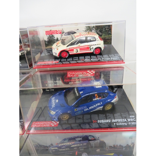 887 - Eight Die Cast Model Rally cars in hard perspex cases.  See photos for details.