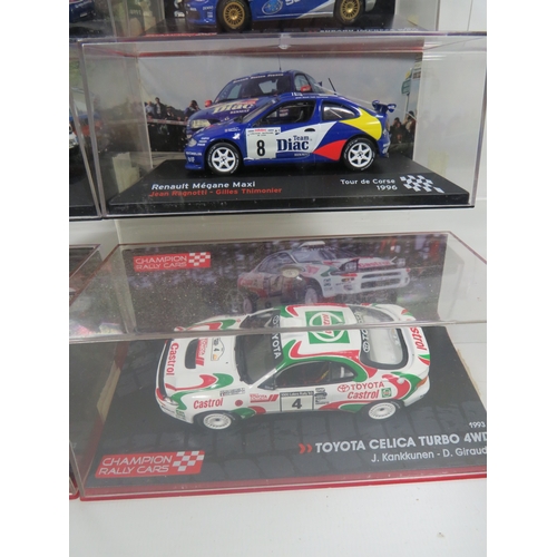 887 - Eight Die Cast Model Rally cars in hard perspex cases.  See photos for details.