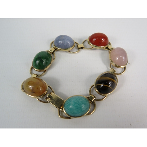 329 - 9ct gold multi semi precious stone cabochon bracelet, 18cm long. Total weight 28.9 grams.