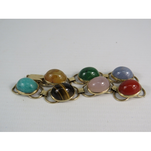 329 - 9ct gold multi semi precious stone cabochon bracelet, 18cm long. Total weight 28.9 grams.