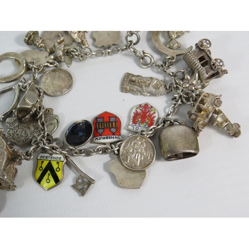 339 - Sterling silver charm bracelet with 24 x 925 & 800 charms. 63.8 grams