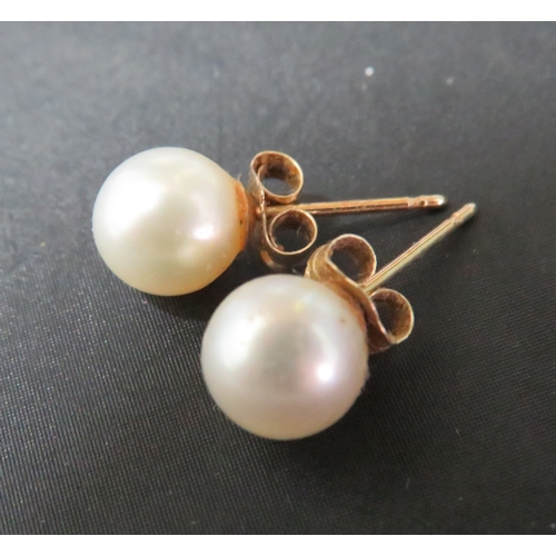 340 - A pair of 9ct gold 6mm pearl stud earrings.