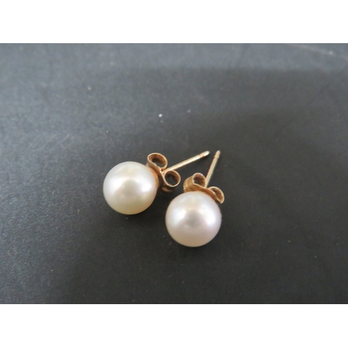 340 - A pair of 9ct gold 6mm pearl stud earrings.