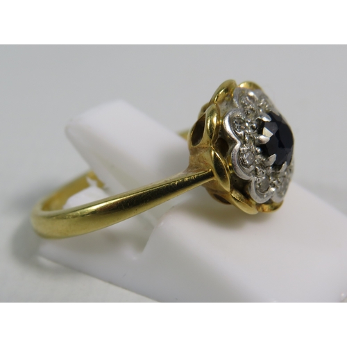 346 - 18ct gold ring set with a 4mm central sapphire and 8 diamonds in a platinum mount, finger size 