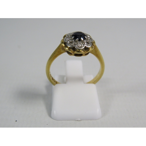 346 - 18ct gold ring set with a 4mm central sapphire and 8 diamonds in a platinum mount, finger size 