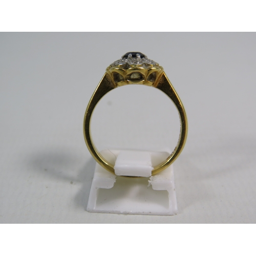 346 - 18ct gold ring set with a 4mm central sapphire and 8 diamonds in a platinum mount, finger size 