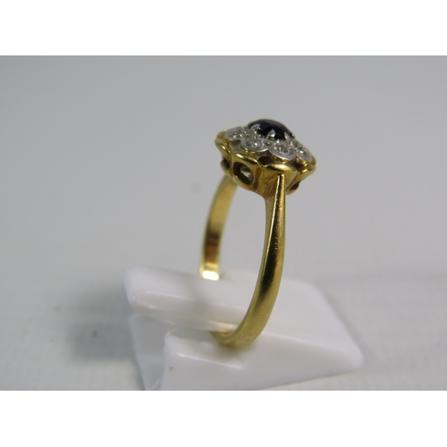 346 - 18ct gold ring set with a 4mm central sapphire and 8 diamonds in a platinum mount, finger size 