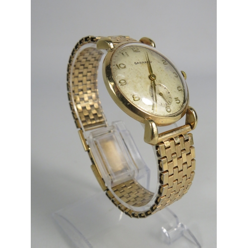 376 - Gents Garrard wristwatch with 9ct gold body and rolled gold strap, in running order. (inscription to... 