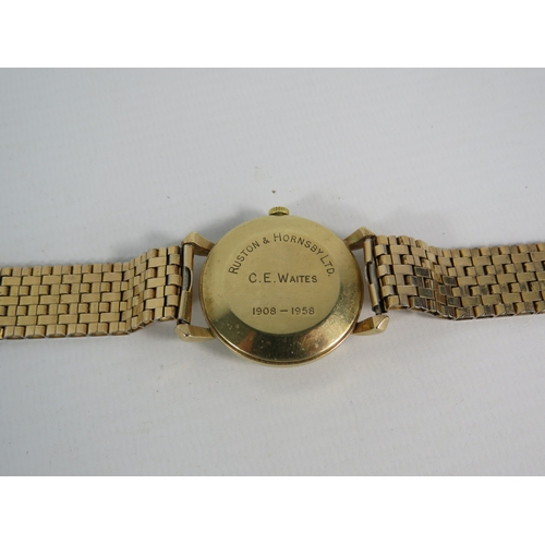 376 - Gents Garrard wristwatch with 9ct gold body and rolled gold strap, in running order. (inscription to... 