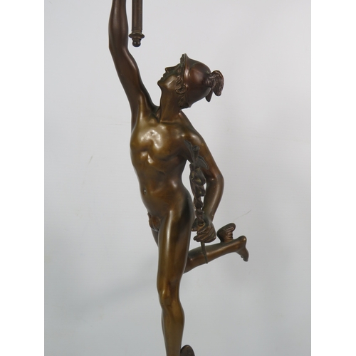 403 - A Bronze alloy figure of Hermes with a frosted glass flame shade, standing on a cherub decorated pli... 