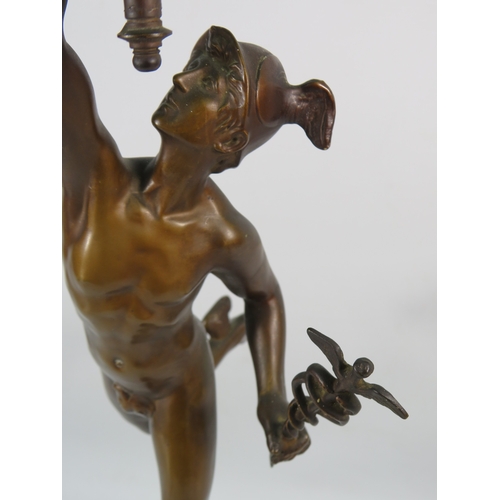 403 - A Bronze alloy figure of Hermes with a frosted glass flame shade, standing on a cherub decorated pli... 