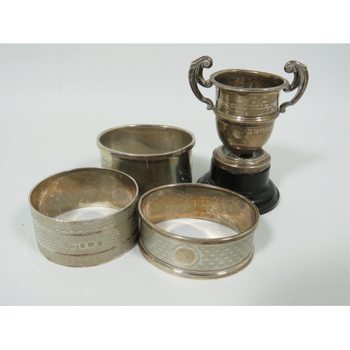 991 - Selection of Hallmarked Silver Napkin Rings plus a small trophy.  Total Silver weight approx 63.1g .... 