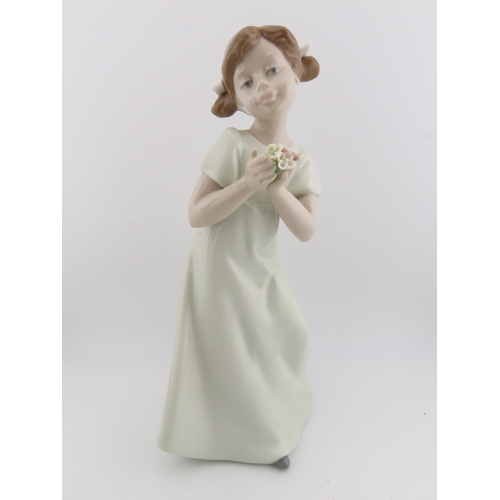 14 - Two Nao figurines of girls plus one by Nadal, the tallest stands 10