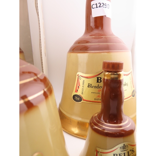 42 - Five Full sealed Bells whisky Wade bell decanters, various sizes and one still boxed.