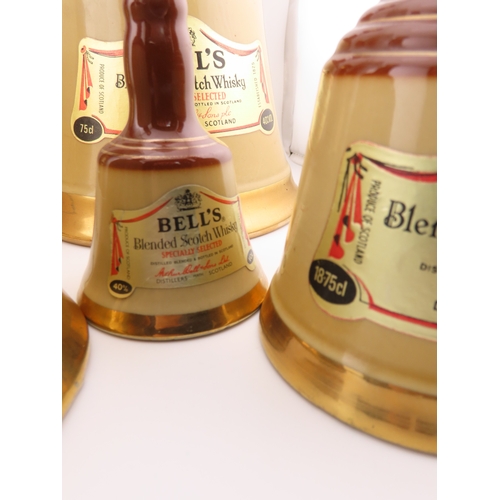 42 - Five Full sealed Bells whisky Wade bell decanters, various sizes and one still boxed.