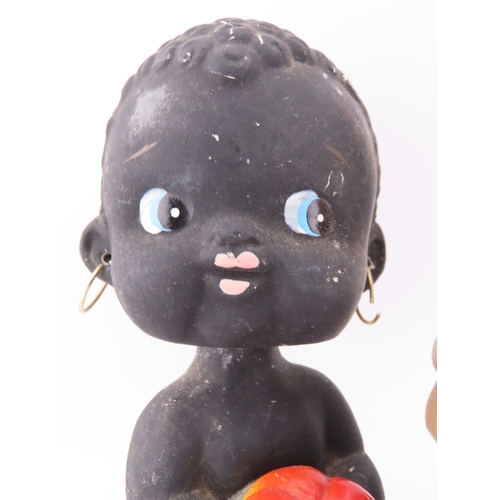 53 - Vintage Kewpie bobblehead money bank and a German bobble head figure.