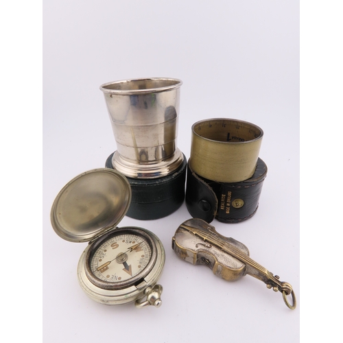 294 - White metal vesta case, folding stirrup cup, tape measure and small compass, assorted early 20th cen... 