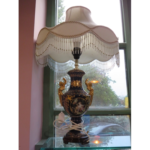 484 - Decorative porcelain and gilt table lamp with ornate shade, approx. 30 inches tall.