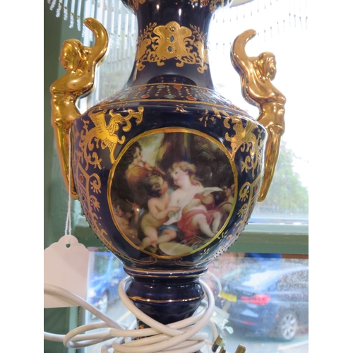 484 - Decorative porcelain and gilt table lamp with ornate shade, approx. 30 inches tall.