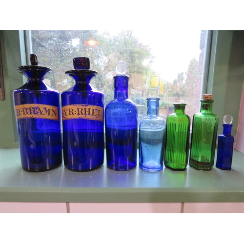 485 - Collection of seven coloured glass apothecary bottles, tallest approx. 9 inches.