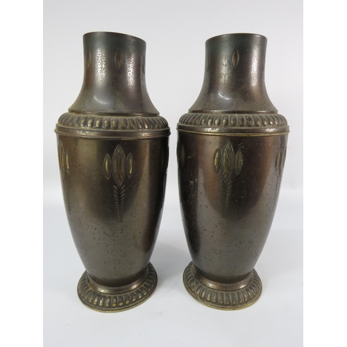 489 - Pair of patinated brass vases with embossed detailing, approx. 15 inches tall.